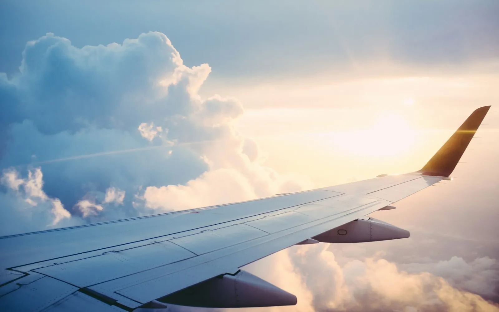 An airplane wing above the clouds: autopilot does the flying, but a pilot is still in command